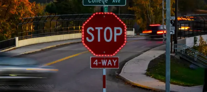 Red stop sign with flashing lights